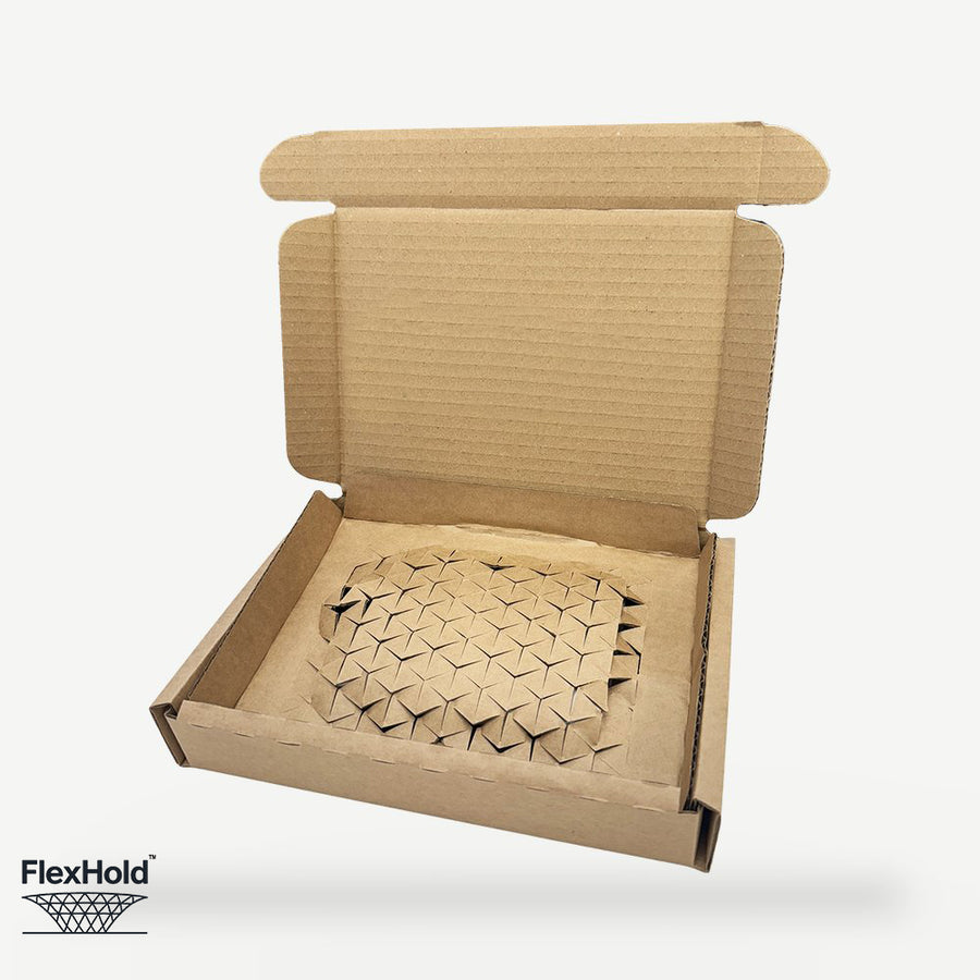 FlexHold box open showing the integrated cardboard retention panel holding a product in place